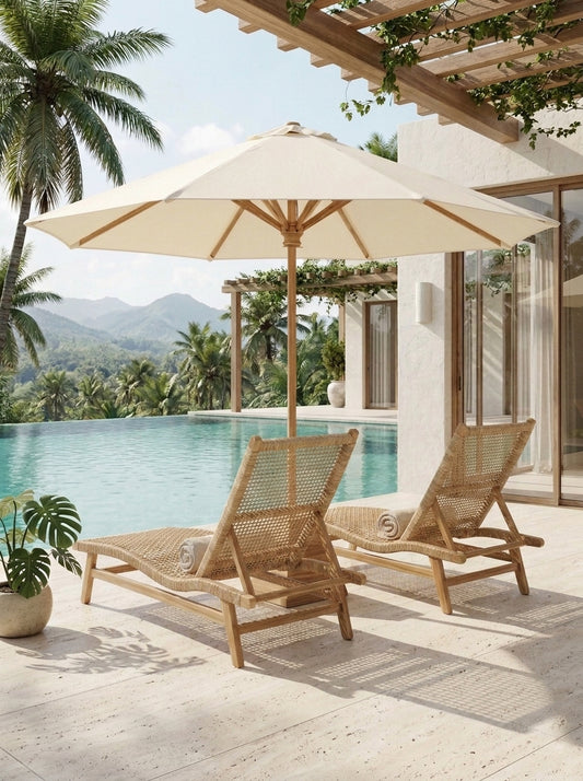 Two woven rattan lounge chairs with matching beige patio umbrellas on a light stone deck beside a swimming pool, with palm trees and a modern house in the background.